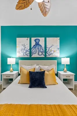 a bedroom with a large white bed with two lamps at Beachfront Bliss at Ocean Ritz! 3BR 3BA! Sleeps 10 by Dolce Vita Getaways PCB in Panama City Beach