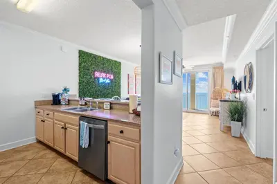 a kitchen with a sink and a counter at Beachfront Bliss at Ocean Ritz! 3BR 3BA! Sleeps 10 by Dolce Vita Getaways PCB in Panama City Beach