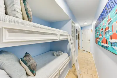 a bunk bed in a room with blue walls at Walk to Pool and Beach PCB Resort Getaway with Porch in Panama City Beach