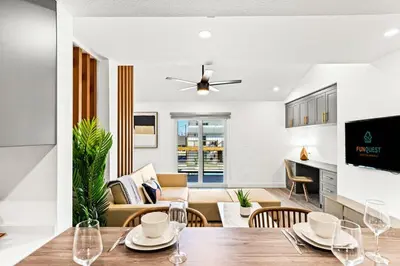 a dining room and living room with a table and chairs at Ocean Breeze 1C in Panama City Beach