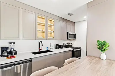 a kitchen with white cabinets and a counter top at Ocean Breeze 1A in Panama City Beach