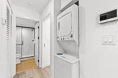 a white bathroom with a sink and a mirror at Ocean Breeze 1B in Panama City Beach