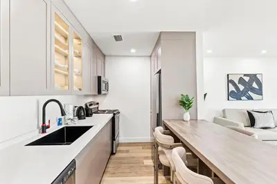 a kitchen with white cabinets and a wooden counter top at Ocean Breeze 1B in Panama City Beach