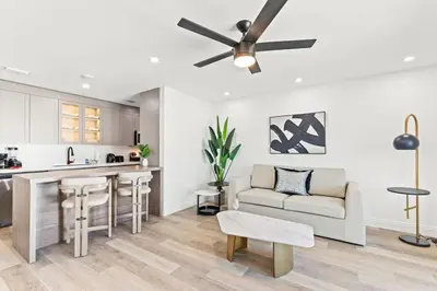 a kitchen and living room with a ceiling fan at Ocean Breeze 2A in Panama City Beach