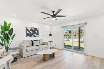 a living room with a couch and a ceiling fan at Ocean Breeze 2A in Panama City Beach
