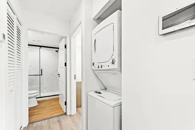 a white bathroom with a sink and a mirror at Ocean Breeze 1D in Panama City Beach