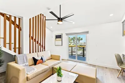 a living room with a couch and a ceiling fan at Ocean Breeze 2D in Panama City Beach