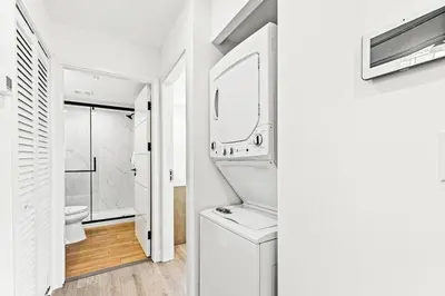 a white bathroom with a sink and a mirror at Ocean Breeze 3C in Panama City Beach