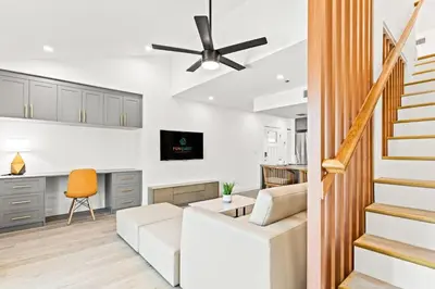 a living room with a white couch and a ceiling fan at Ocean Breeze 3D in Panama City Beach