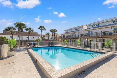 a swimming pool in the courtyard of a apartment building at Ocean Breeze 3B in Panama City Beach