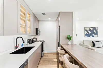 a kitchen with white cabinets and a wooden counter top at Ocean Breeze 3B in Panama City Beach