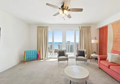 a living room with a couch and a table at BeachFrnt 2 Hottub 5 Pools Jet Ski in Panama City Beach