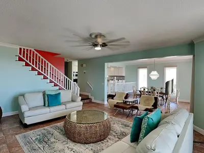 a living room with a couch and a dining room at Lion On The Beach in Panama City Beach