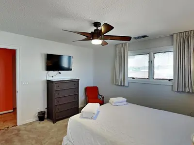 a bedroom with a bed and a ceiling fan at Lion On The Beach in Panama City Beach