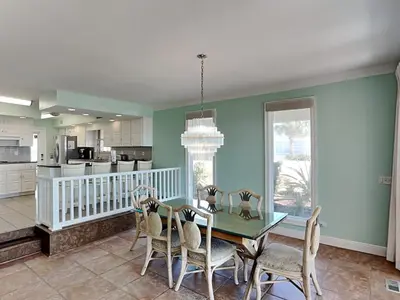 a dining room with a table and chairs at Lion On The Beach in Panama City Beach