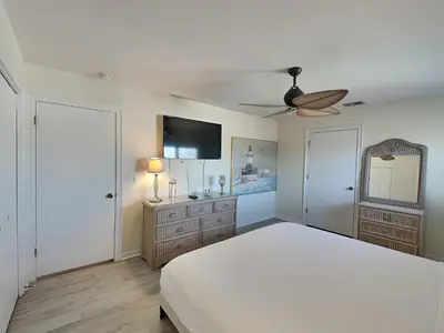 a bedroom with a bed and a ceiling fan at Lion On The Beach in Panama City Beach