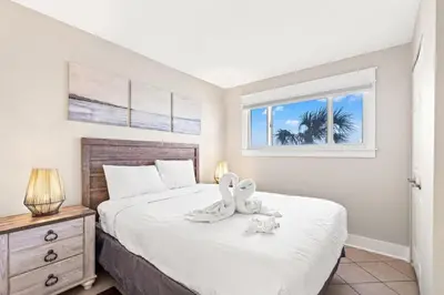 a bedroom with a large white bed with a window at The Summit 301 in Panama City Beach