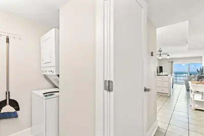 a kitchen with white cabinets and a view of the ocean at The Summit 301 in Panama City Beach