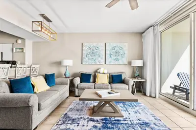a living room with a couch and a table at Spacious 2-Bedroom Condo Beachfront Resort! By Dolce Vita Getaways PCB! in Panama City Beach