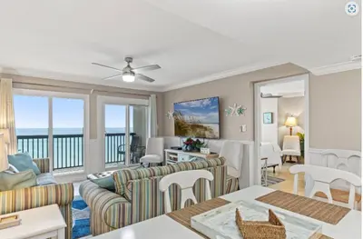 a living room with a couch and a table at Pinnacle Port B3-706 in Panama City Beach