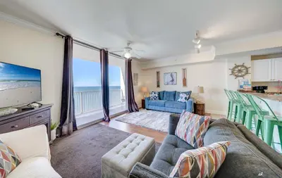 a living room with a couch and a tv at Stunning Beach front condo in Panama City Beach