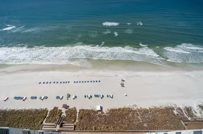 an overhead view of a beach with chairs and the ocean at Stunning Beach front condo in Panama City Beach