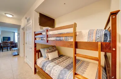 two bunk beds in a room with a hallway at Stunning Beach front condo in Panama City Beach