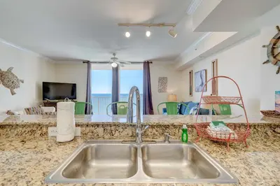a kitchen sink with a view of the ocean at Stunning Beach front condo in Panama City Beach