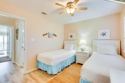 a bedroom with two beds and a ceiling fan at Steps to Sand PCB Condo with Gulf-View Balconies! in Panama City Beach