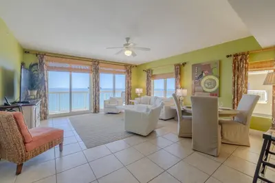 a living room with a view of the ocean at Calypso Resort By Sand Seeker Vacations in Panama City Beach