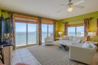 a living room with a couch and a table at Calypso Resort By Sand Seeker Vacations in Panama City Beach