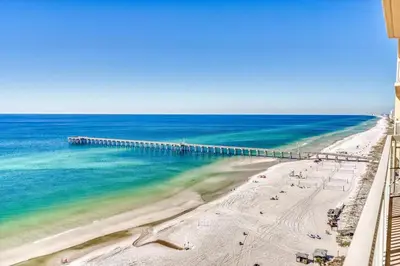 an aerial view of a beach with a pier at Calypso Resort By Sand Seeker Vacations in Panama City Beach