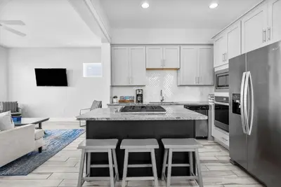 a kitchen with white cabinets and stainless steel appliances at Available for Spring Break! Seas The Day at Inlet Beach in Inlet Beach