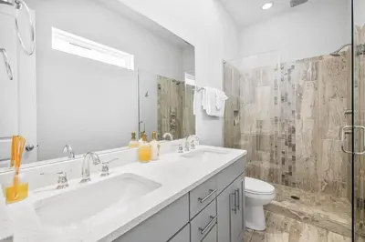 a white bathroom with a sink and a toilet at Available for Spring Break! Seas The Day at Inlet Beach in Inlet Beach