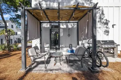 a gazebo with chairs and a table and a grill at Available for Spring Break! Seas The Day at Inlet Beach in Inlet Beach