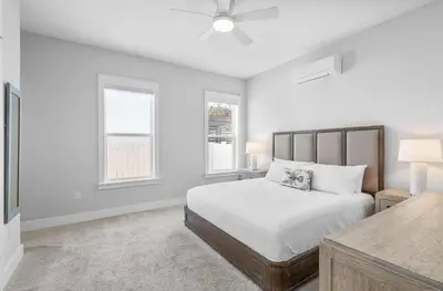 a white bedroom with a bed and two windows at Available for Spring Break! Seas The Day at Inlet Beach in Inlet Beach