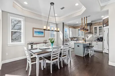a kitchen with a dining room table and chairs at Blue Sky Bungalow in Inlet Beach