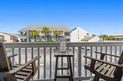 a balcony with two chairs and a house at Endless Summer A36 - 
