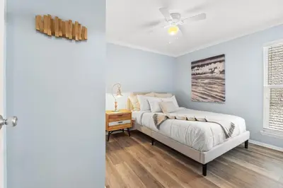 a bedroom with a bed and a dresser and a window at Endless Summer A36 - 