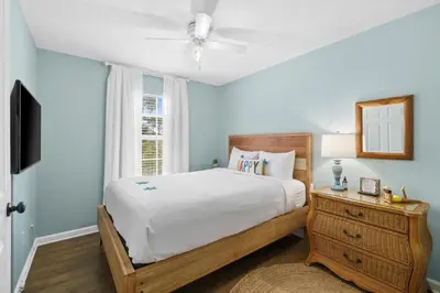 a bedroom with a bed and a window at Beach House - Paradise Palace by Panhandle Getaways in Panama City Beach