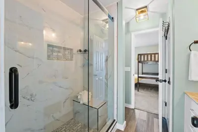 a bathroom with a shower with a glass door at Pet-friendly condo, less than 5 min walk to beach, beach chairs, wagon, umbrella etc. included! in Panama City Beach
