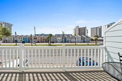a view of the beach from the deck of a house at Pet-friendly condo, less than 5 min walk to beach, beach chairs, wagon, umbrella etc. included! in Panama City Beach