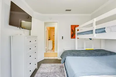 a bedroom with a bed and a bunk bed at Boat Dock and Game Room Waterfront Panama City Gem in Lynn Haven