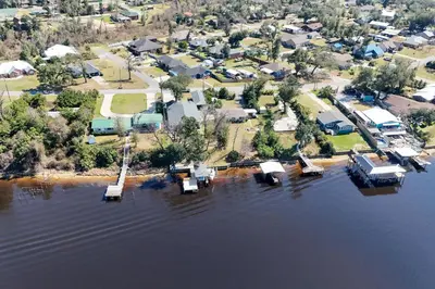 an aerial view of a house in the water at Boat Dock and Game Room Waterfront Panama City Gem in Lynn Haven