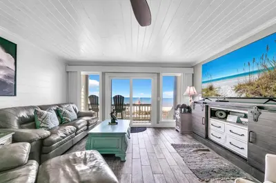 a living room with a couch and a pool table at Ocean Bliss by Emerald Coast Retreats in Panama City Beach
