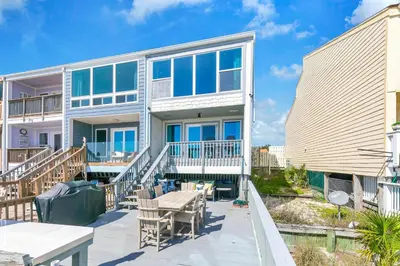 a house with a patio and a table at Ocean Bliss by Emerald Coast Retreats in Panama City Beach