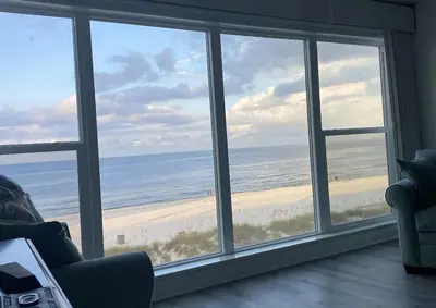 a living room with a view of the beach at Ocean Bliss by Emerald Coast Retreats in Panama City Beach