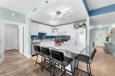 a kitchen with a large white table and chairs at Laketown Wharf #0722 in Panama City Beach