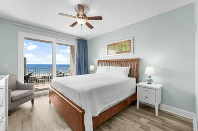 a bedroom with a bed and a view of the ocean at Laketown Wharf #0722 in Panama City Beach