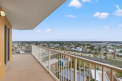 a balcony with a view of a city at Treasure Shores–3BR Beachfront Corner Unit sleeps 8 with Stunning Gulf Views! in Panama City Beach